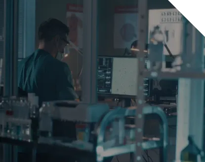 Laboratory with one person wearing a full protective gear and a lot of medical equipment in the background