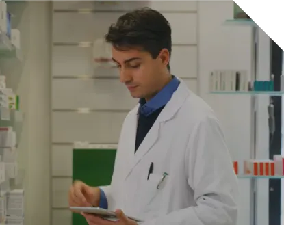 Male medical staff writing something down in his notes while standing